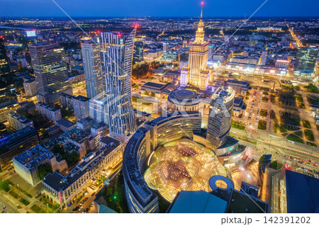 Warm-lit Warsaw Palace of Culture landmark skyline at blue hour in Poland Warm-lit Warsaw Palace of Culture landmark skyline at blue hour in Poland 142391202
