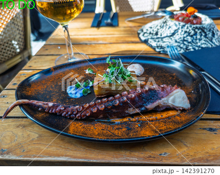 Gourmet grilled octopus tentacle with potato gratin in Spain Gourmet grilled octopus tentacle with potato gratin in Spain 142391270