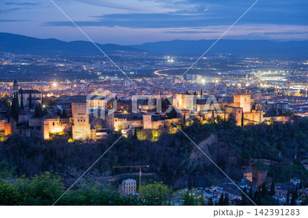 Illuminated Alhambra fortress and Granada cityscape at dusk Illuminated Alhambra fortress and Granada cityscape at dusk 142391283