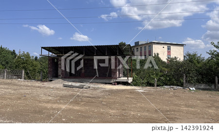 Rural unfinished building with dirt foreground Rural unfinished building with dirt foreground 142391924