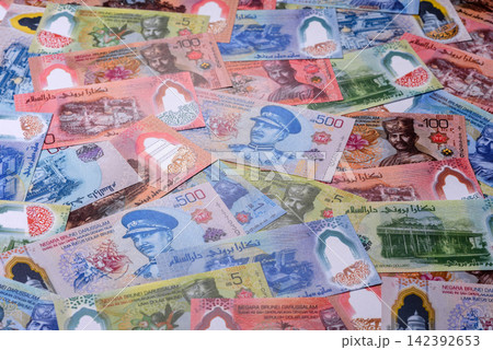 Brunei paper money, dollar banknotes and sen coins as currency for exchange or travel. Brunei money Brunei paper money, dollar banknotes and sen coins as currency for exchange or travel. Brunei money 142392653