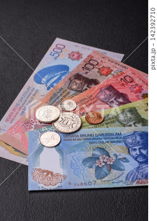 Brunei paper money, dollar banknotes and sen coins as currency for exchange or travel. Brunei money Brunei paper money, dollar banknotes and sen coins as currency for exchange or travel. Brunei money 142392710