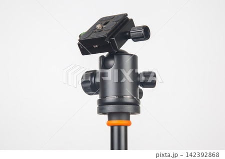 Camera tripod head on a support structure in a studio setting for photography Camera tripod head on a support structure in a studio setting for photography 142392868