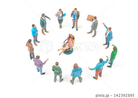 Miniature people in a meeting around a central figure seated in a chair 142392895