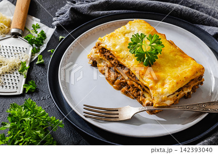 Baked lasagna square with beef, sauce, cheese Baked lasagna square with beef, sauce, cheese 142393040