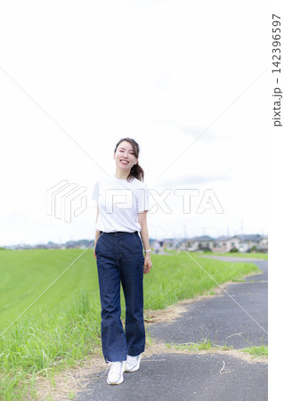 草原や河原を散歩する女性 142396597