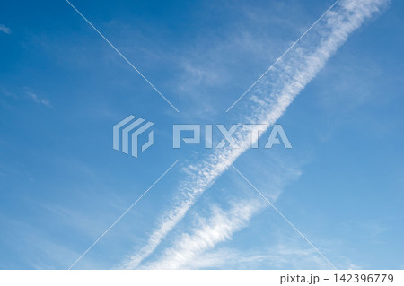 夏の夕暮れ空に輝く飛行機雲が棚びく01 142396779