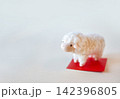 赤色敷紙に乗ったひつじの年賀状　文字なし 142396805