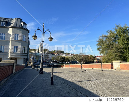 Pedestrian bridge with street lamps in Przemysl Poland on a sunny day Pedestrian bridge with street lamps in Przemysl Poland on a sunny day 142397694