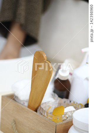 a wooden spa and bath accessory, appearing to be a long-handled wooden body brush 142398960