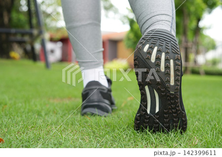 Woman is walking exercise at the park Woman is walking exercise at the park 142399611
