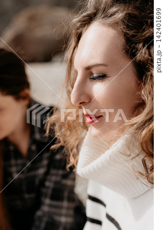 Woman Profile Curly hair peaceful model with red lips and striped sweater outdoors enjoying the sunlit autumn afternoon 142401699