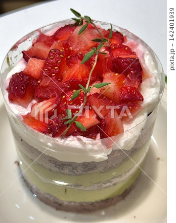 Strawberry cake with soft fluffy layers, topped with fresh strawberries and smooth cream, showcasing vibrant red fruit, delicate textures, and sweet inviting appearance in close-up detail Strawberry cake with soft fluffy layers, topped with fresh strawberries and smooth cream, showcasing vibrant red fruit, delicate textures, and sweet inviting appearance in close-up detail 142401939