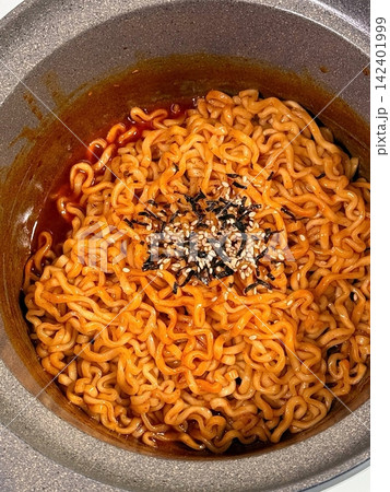 Spicy buldak ramyeon with fiery hot sauce and chewy noodles, delivering an intense, flavorful kick in every bite. A perfect choice for those who crave bold, spicy Korean comfort food. Spicy buldak ramyeon with fiery hot sauce and chewy noodles, delivering an intense, flavorful kick in every bite. A perfect choice for those who crave bold, spicy Korean comfort food. 142401999