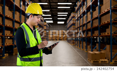 Warehouse Worker in Safety Vest and Yellow Hardhat Using Digital Tablet for Inventory Management in Large Storage Facility Warehouse Worker in Safety Vest and Yellow Hardhat Using Digital Tablet for Inventory Management in Large Storage Facility 142402754