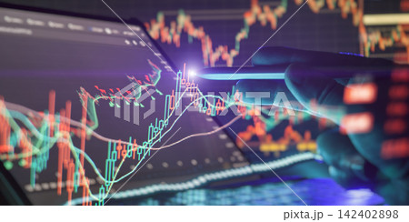 Business analytics concept showing a hand pointing at glowing cryptocurrency trading graphs on a modern dashboard. 142402898