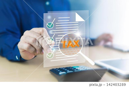 Person reviewing digital tax document with magnifying glass Person reviewing digital tax document with magnifying glass 142403289