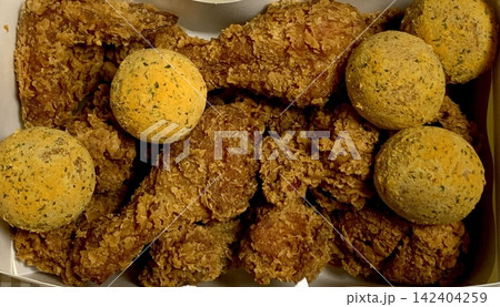 Crispy Korean fried chicken, perfectly glazed with a sweet and spicy sauce. Ideal for food photography and menus, showcasing the irresistible crunch and flavor of this beloved dish. 142404259