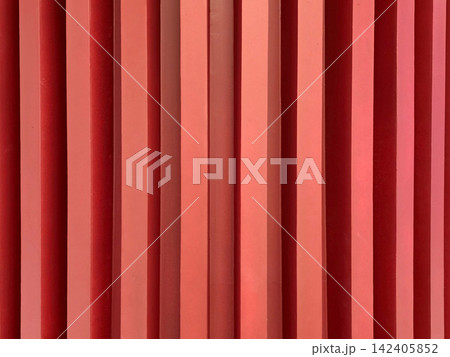 Abstract background of red vertical slats with deep shadows. Minimalist architectural detail featuring rhythmic geometric patterns and vibrant color. Ideal for modern design projects. 142405852