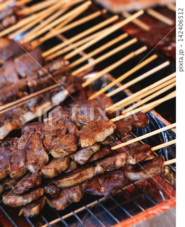 Wagyu beef skewers grilling on hot teppanyaki teppan iron plate, premium Japanese marbled meat on wooden sticks, traditional street food festival, Tokyo, Japan, market with local vendor stalls cooking Wagyu beef skewers grilling on hot teppanyaki teppan iron plate, premium Japanese marbled meat on wooden sticks, traditional street food festival, Tokyo, Japan, market with local vendor stalls cooking 142406512