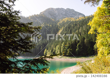 Beautiful view of lake. Rocky shore of mountain lake in the morning. Travelling, lifestyle, nature Beautiful view of lake. Rocky shore of mountain lake in the morning. Travelling, lifestyle, nature 142408166