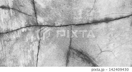 Textured gray concrete wall with deep structural cracks. 142409430