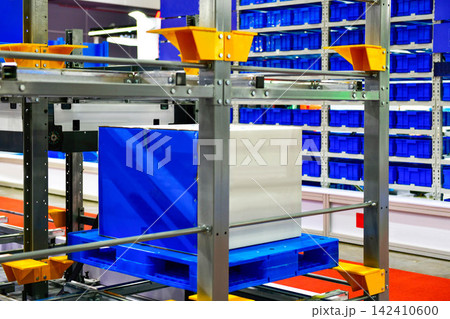 Industrial cardboard box package stored on automated racking system in smart logistics warehouse Industrial cardboard box package stored on automated racking system in smart logistics warehouse 142410600