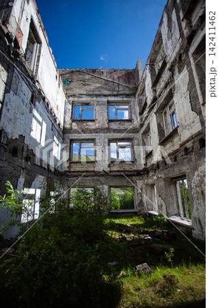 Abandoned Soviet-era Palace of Culture in the former mining settlement of Kukisvumchorr near Kirovsk, Murmansk Region, Russia. The decaying cultural building stands beneath the Khibiny Mountains, surr 142411462