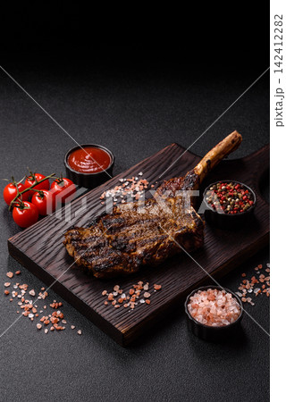 Grilled beef Tomahawk steak seasoned with salt and spices. Tomahawk steak 142412282