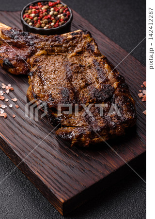 Grilled beef Tomahawk steak seasoned with salt and spices. Tomahawk steak Grilled beef Tomahawk steak seasoned with salt and spices. Tomahawk steak 142412287