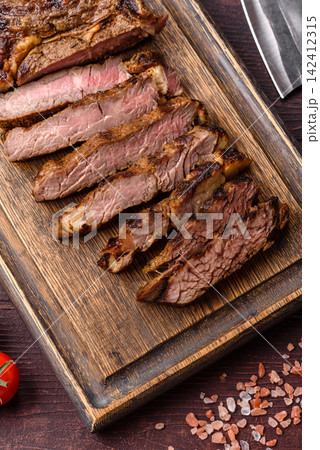 Grilled beef Tomahawk steak seasoned with salt and spices. Tomahawk steak 142412315