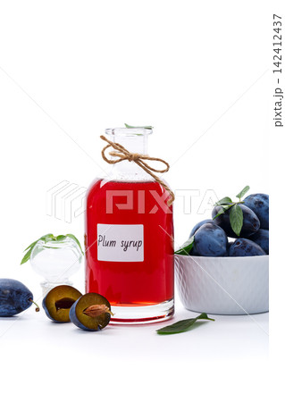 Homemade plum syrup with fresh fruit on white background Homemade plum syrup with fresh fruit on white background 142412437