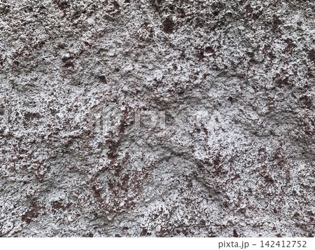 Rough wall texture background with weathered white plaster and exposed red concrete 142412752