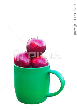 Plums stacked in green ceramic mug on white Plums stacked in green ceramic mug on white 142413283