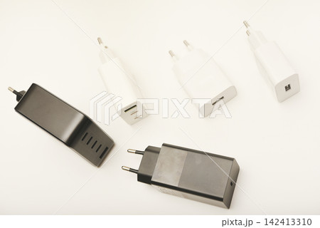 Black and white power supplies for mobile devices. Powerful power supplies on a white background. Charging devices for gadgets. Black and white power supplies for mobile devices. Powerful power supplies on a white background. Charging devices for gadgets. 142413310