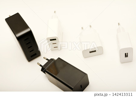 Black and white power supplies for mobile devices. Powerful power supplies on a white background. Charging devices for gadgets. Black and white power supplies for mobile devices. Powerful power supplies on a white background. Charging devices for gadgets. 142413311