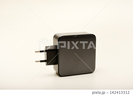 Black power supply for a mobile device. Powerful power supplies on a white background. Black power supply for a mobile device. Powerful power supplies on a white background. 142413312