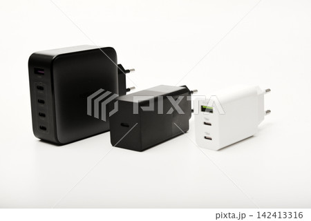 Black and white power supplies for mobile devices. Powerful power supplies on a white background. Charging devices for gadgets. Black and white power supplies for mobile devices. Powerful power supplies on a white background. Charging devices for gadgets. 142413316