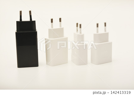 Black and white power supplies for mobile devices. Powerful power supplies on a white background. Charging devices for gadgets. Black and white power supplies for mobile devices. Powerful power supplies on a white background. Charging devices for gadgets. 142413319