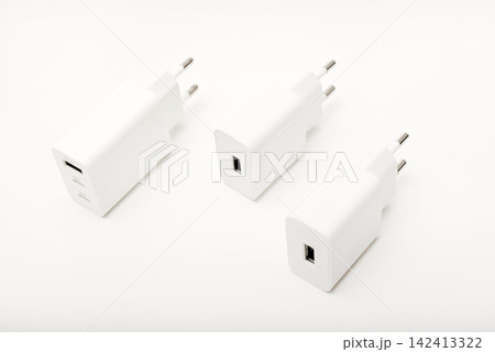 White power supply for a mobile device. Powerful power supplies on a white background. White power supply for a mobile device. Powerful power supplies on a white background. 142413322