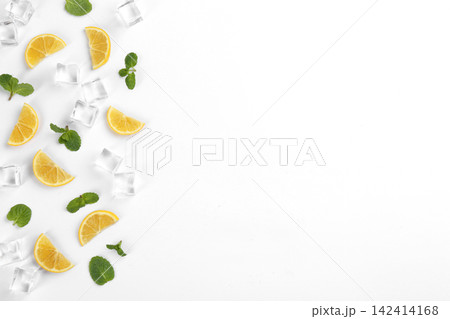 Lemonade layout with lemon slices, mint and ice cubes on white background, top view Lemonade layout with lemon slices, mint and ice cubes on white background, top view 142414168