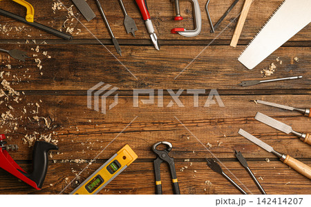 Frame made with carpenter's tools on wooden background, flat lay. Space for text Frame made with carpenter's tools on wooden background, flat lay. Space for text 142414207