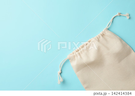 Cotton eco bag on light blue background, top view. Space for text Cotton eco bag on light blue background, top view. Space for text 142414384