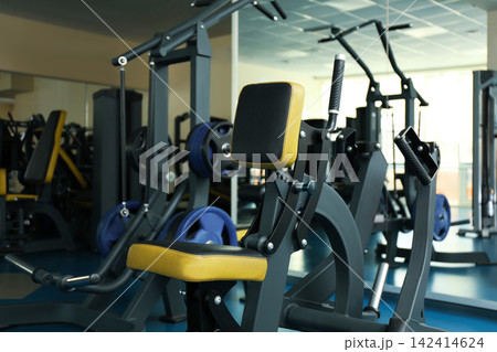 Seated rowing hammer machine in modern gym 142414624