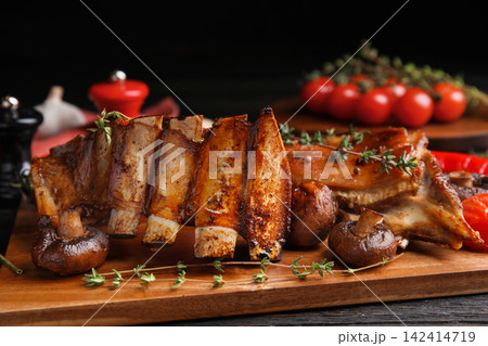 Delicious roasted ribs served on table, closeup Delicious roasted ribs served on table, closeup 142414719