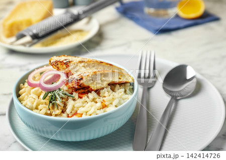 Delicious chicken risotto served in bowl on table Delicious chicken risotto served in bowl on table 142414726
