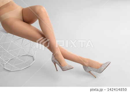Woman wearing tights and stylish shoes on light grey background, closeup of legs Woman wearing tights and stylish shoes on light grey background, closeup of legs 142414850