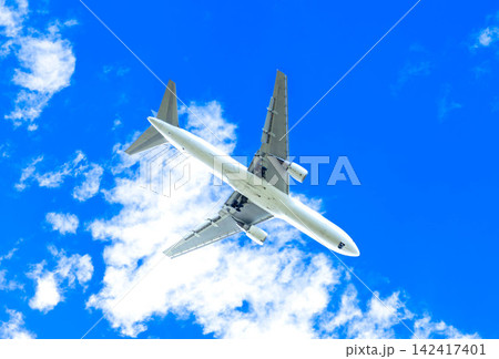 爽やかな青空の下爆音をあげて着陸態勢に入ったかっこいい飛行機 142417401