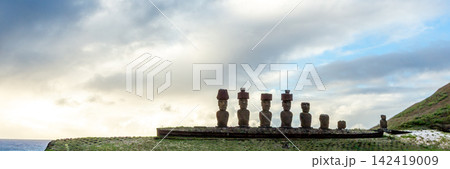 Ahu Nau Nau Moai Statues with Red Topknots at Anakena Beach on Easter Island, Valparaiso, Chile. Banner Web, Copy Space Ahu Nau Nau Moai Statues with Red Topknots at Anakena Beach on Easter Island, Valparaiso, Chile. Banner Web, Copy Space 142419009