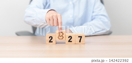 2027 year block with jigsaw puzzle icon. Business Process, Team, teamwork, Goal, mission, Resolution, strategy, plan, Action, partnership, and New Year start 142422392